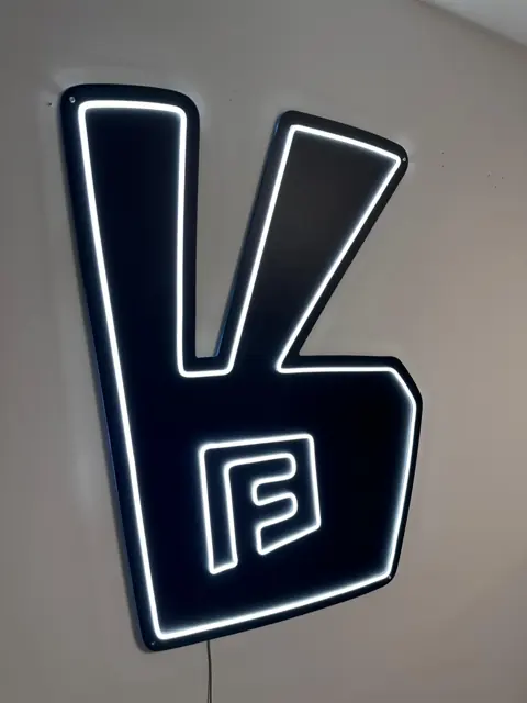 Baltas LED neonas logotipo forma ant juodo matinio akrilo pagrindo